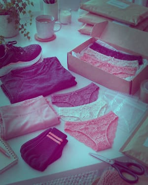 Lace panties bottoms, black tights and socks arranged with zip-lock bags and anonymous parcel packaging